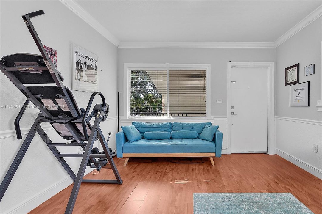 View of living room from inside. All windows come with custom white blinds.