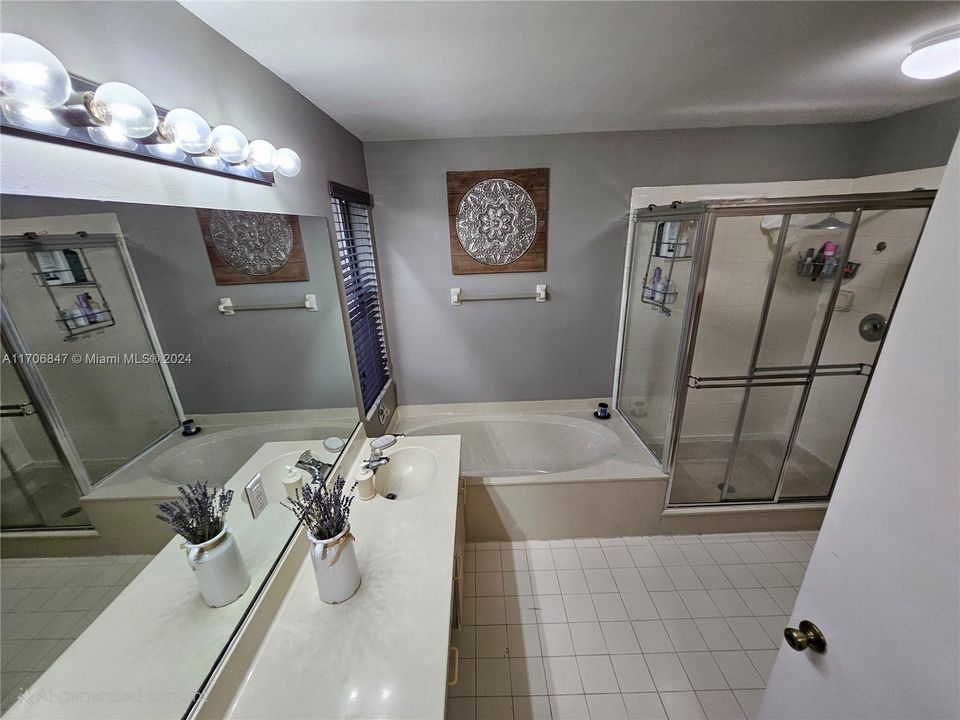 dual sinks, separate shower, and tub