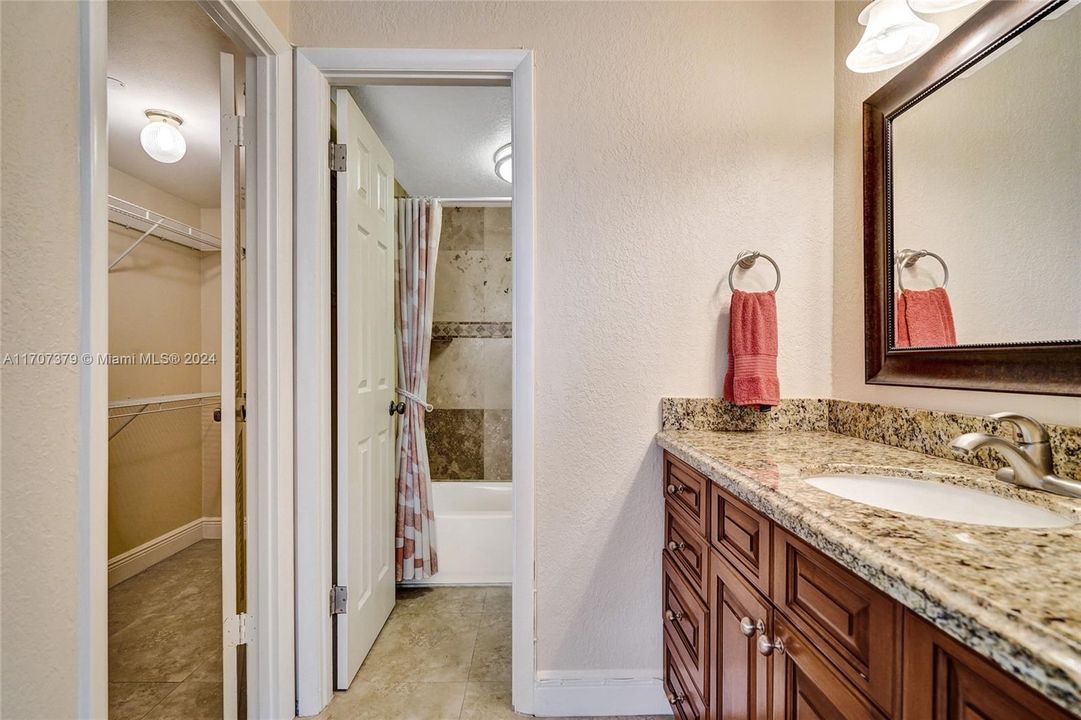 Second bathroom with bathtub and walk in closet