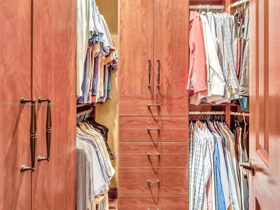 Dual walk-in closets with custom built-ins