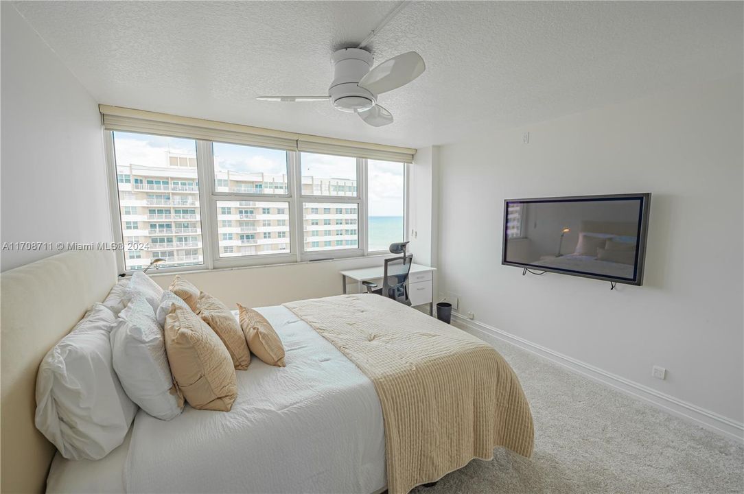 SECOND BEDROOM WITH BRIGHT WALL TO WALL WINDOWS