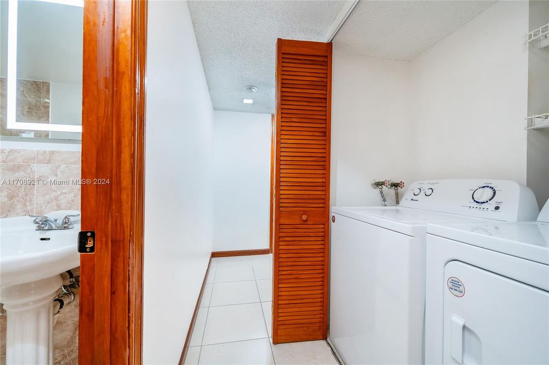 Hallway to bedrooms with Laundry on right