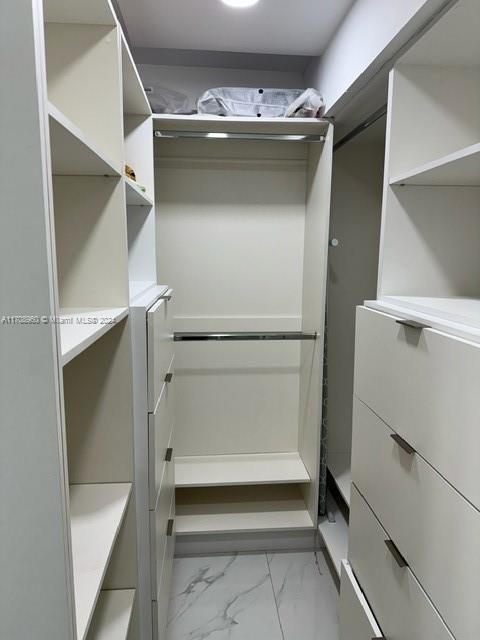 Walk-in closet in primary bedroom