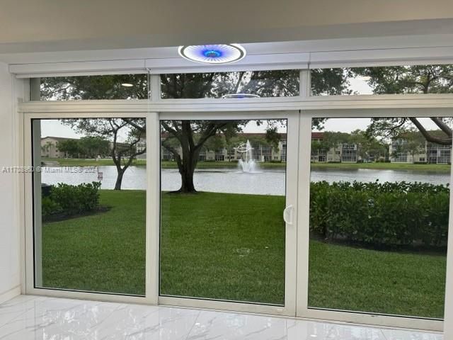 View of Lighted water fountain from enclosed balcony