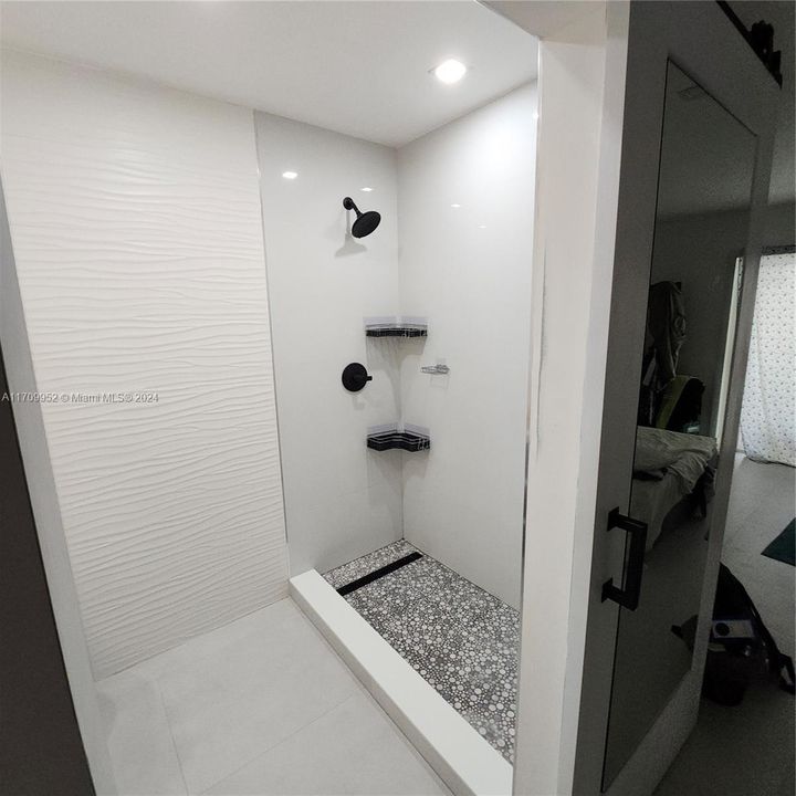 Bathroom Primary Bedroom with Sliding Door and Mirror