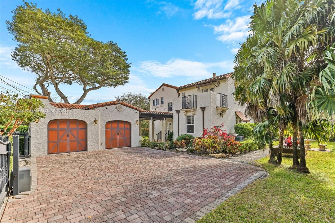 Enclosed driveway w detached two and a half car garage