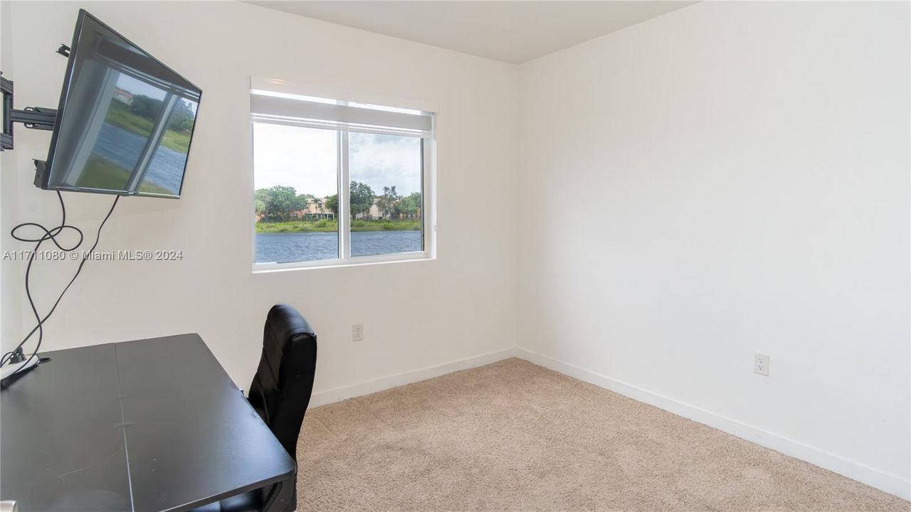 One of the upstairs bedrooms. Currently being used as an office. Beautiful water view.