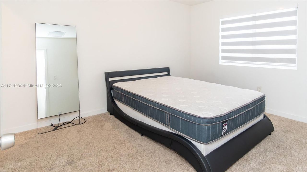 Primary bedroom. Note the custom Zebra blinds!