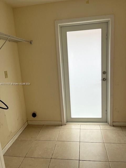 Laundry Room with an exit to a side to the house.