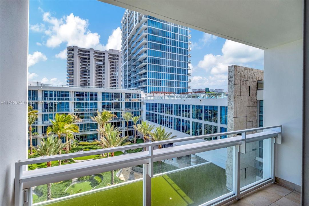 Private South-facing balcony; one of two spacious balconies for this unit.