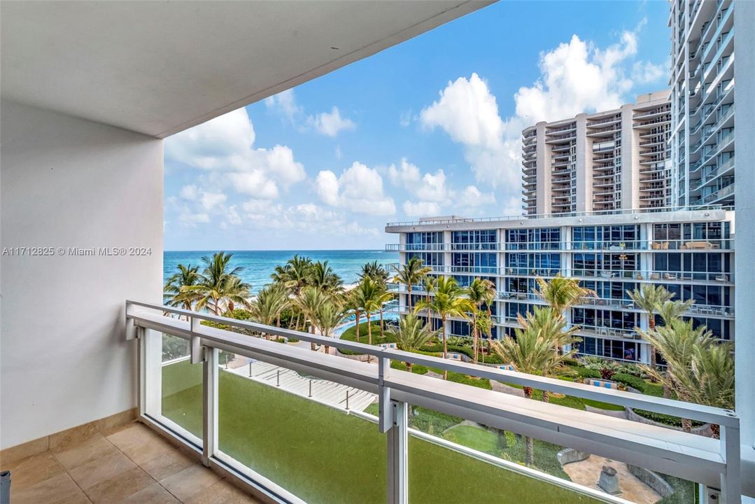 Private South-facing balcony; one of two spacious balconies for this unit.