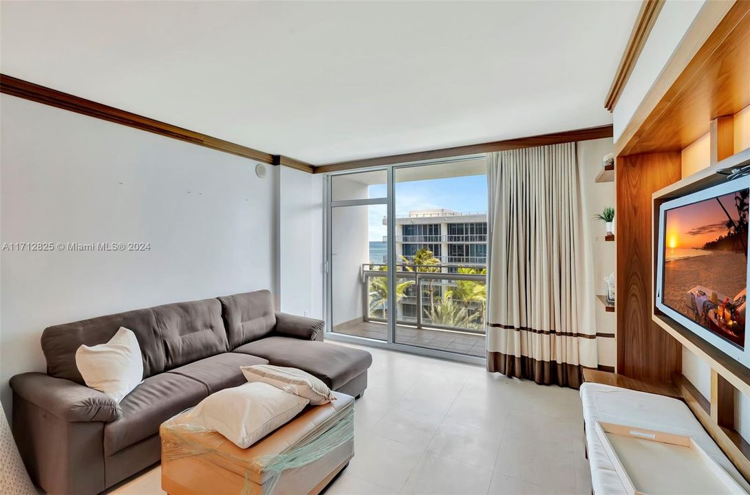 Spacious open floor plan with floor to ceiling windows and balcony of high impact glass.