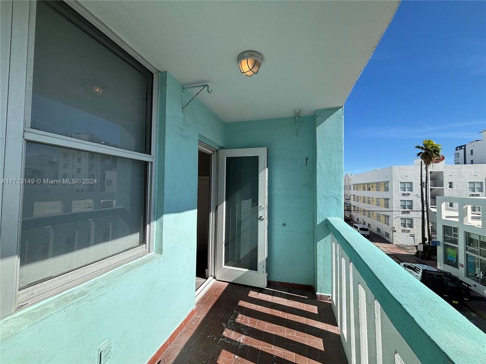 Sunny balcony with the beach in the background.