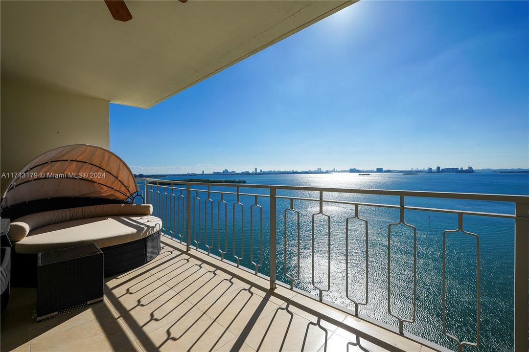 A Spacious Balcony with enough room for table and chairs and a circular chaise lounge to relax in with a good book