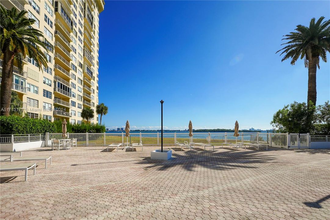 Community pool and pool deck have incredible bay views