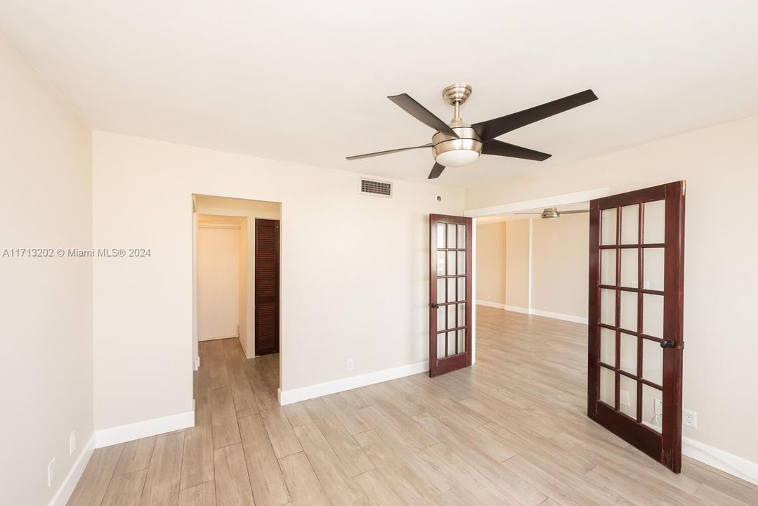 Bedroom view to closet and French door.