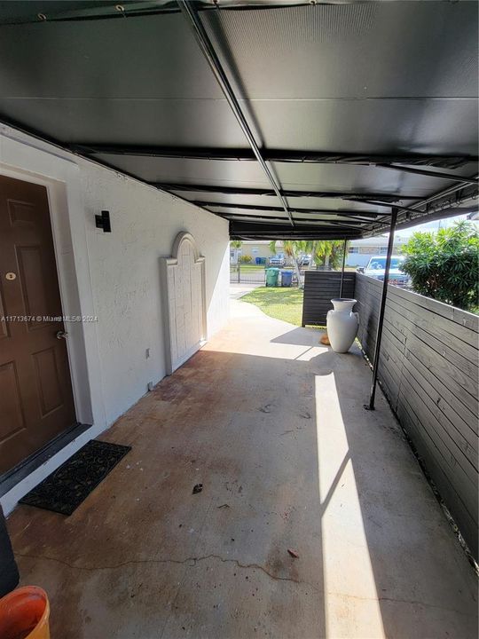 ENTRANCE ON SIDE OF HOUSE UNDER AWNING