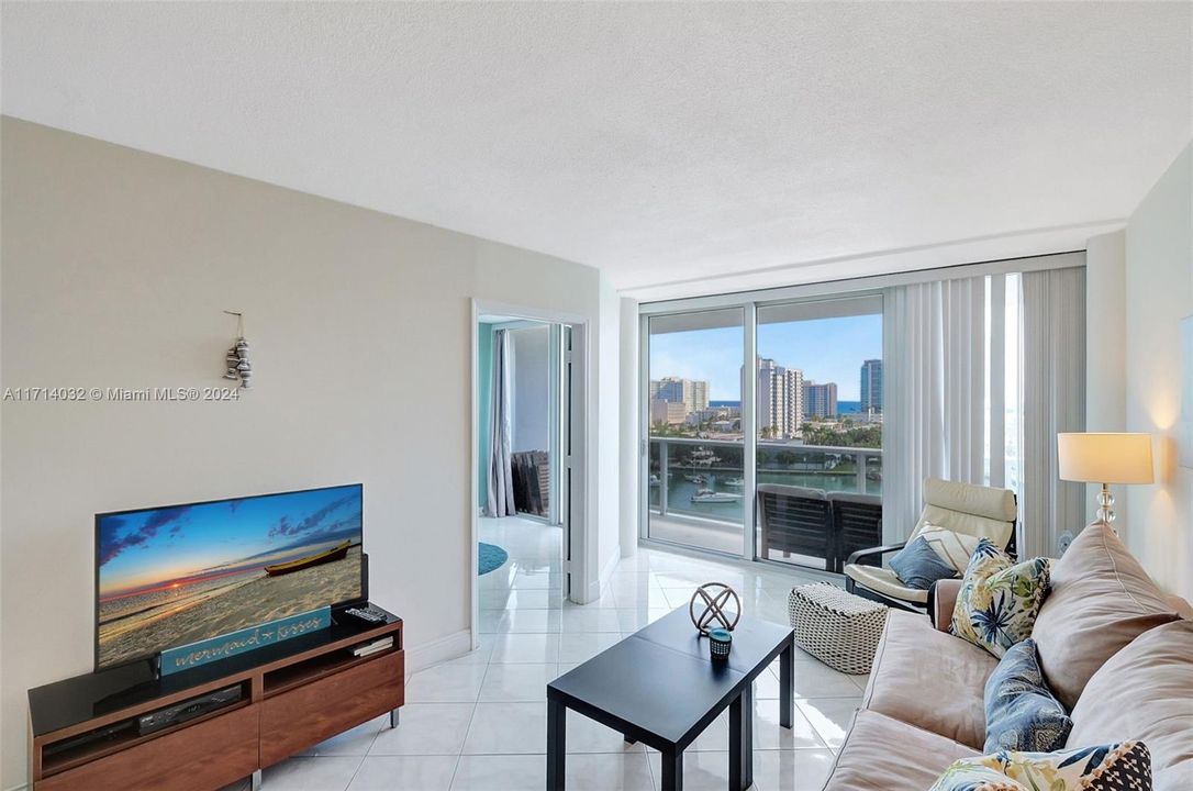 Looking towards Primary bedroom which also has floor to ceiling impact glass overlooking the Atlantic Ocean, Intracoastal Bay and luxury residential Allison Island.