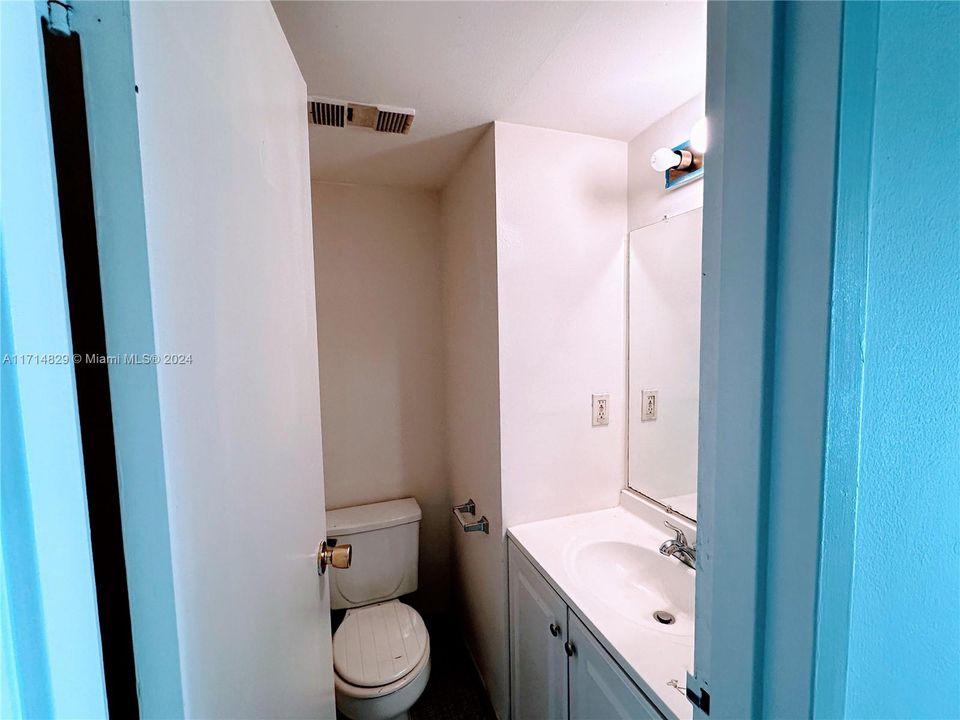 Half bathroom by kitchen