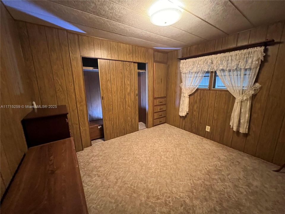 2nd Bedroom with wall full of closets