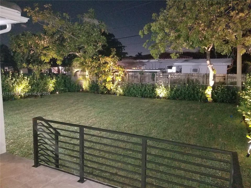 Lit up back yard, new, fresh grass planted.