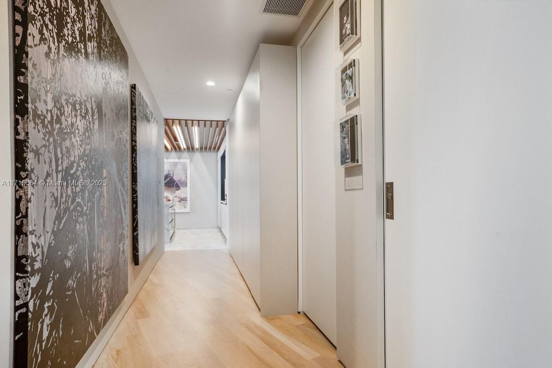 Entry hallway with built-in storage by California Closets