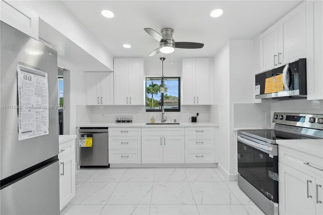 An ALL-NEW kitchen with appliances and cabinets makes the perfect location for meal prep and socializing