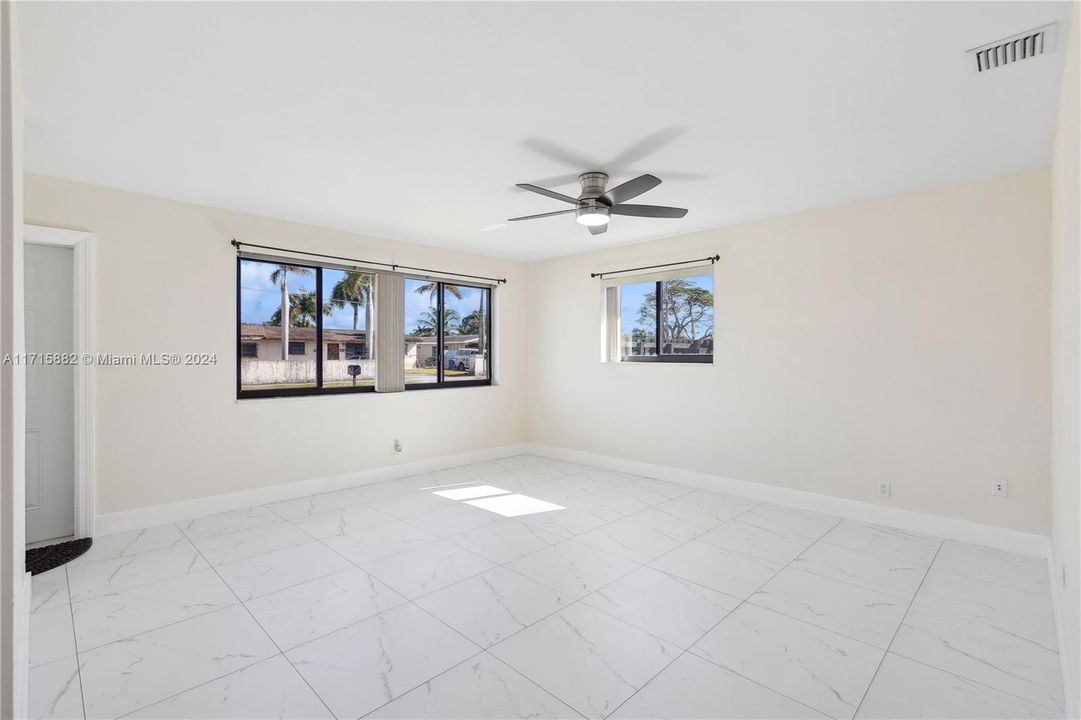 Lots of natural light flows into the living room along with the screened impact windows that allow for a nice breeze throughout the home