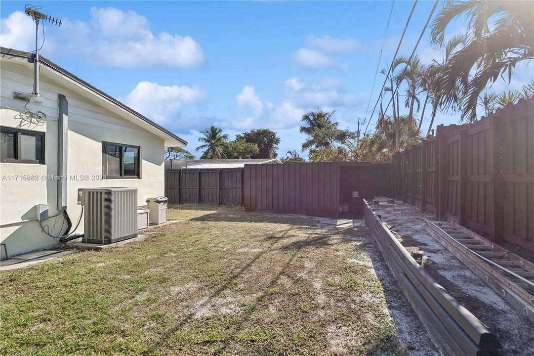 Backyard looking south. Large storage shed with plenty of shelving