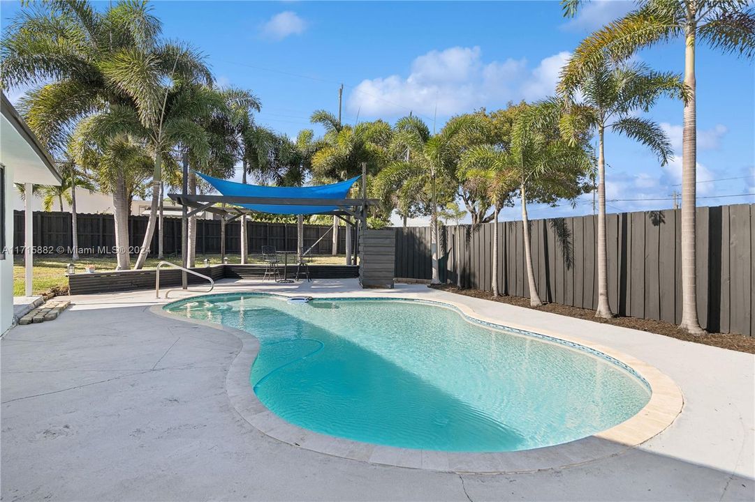 Resurfaced pool with pool cleaner, outdoor shower, new deck and covered pergola