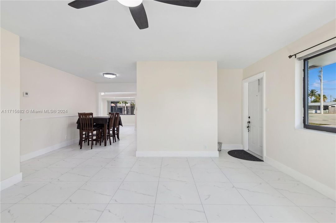 A large living room that flows through the house to the large back yard spaces