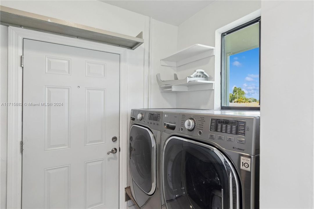 Laundry room has plenty of storage and a pocket door to close off from kitchen when needed