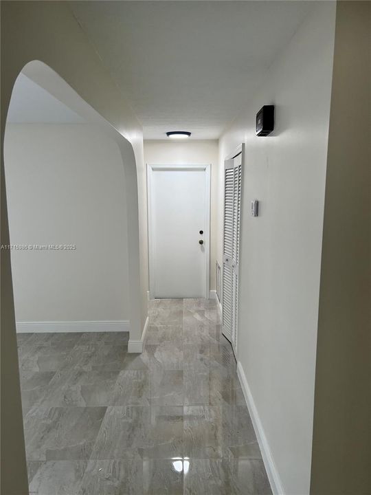 Hallway facing garage door and main door