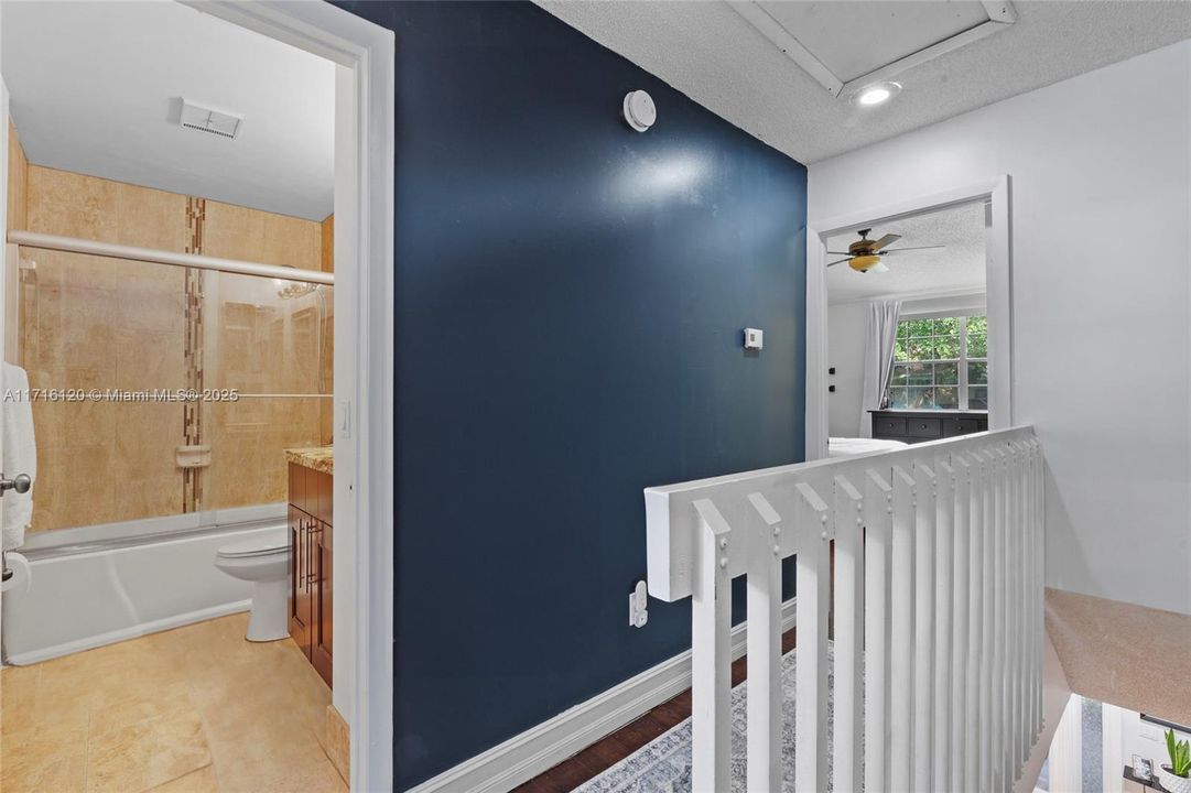 Hallway upstairs with view of guest bathroom