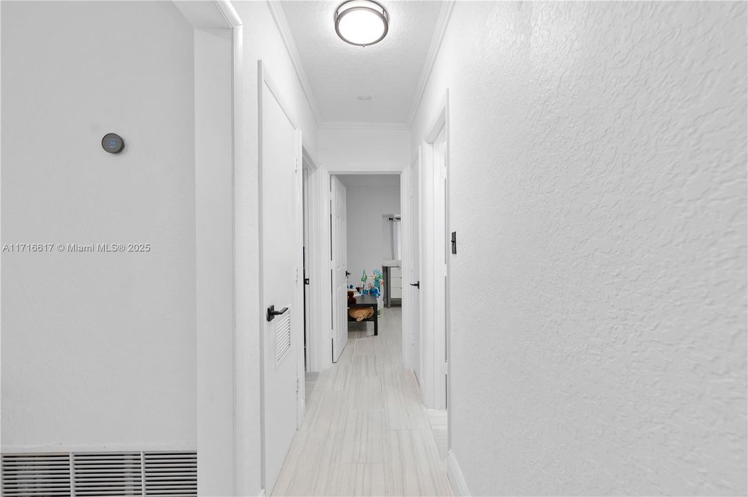 Hallway leading to bedrooms 2 and 3 and 2nd bathroom