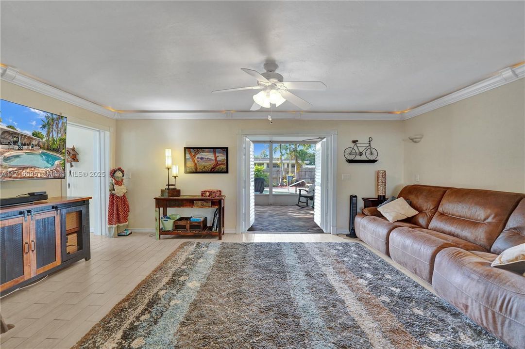 Den leading to Screened porch/pool