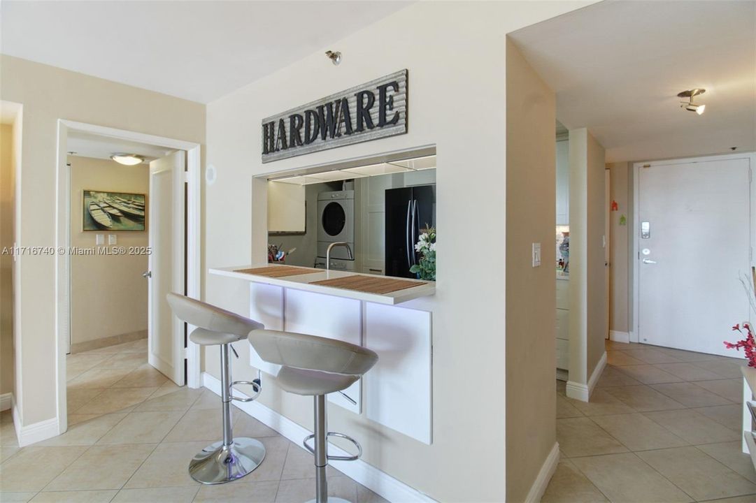 Living / Dining area spacious for dining table if desired.  Open kitchen allows for connectedness and entertaining.  Back right is the entry and to the left of it behind the kitchen is the half-bath.