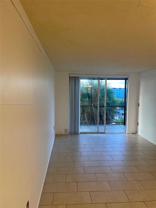 View from the Kitchen into the Living Room and outside Balcony.