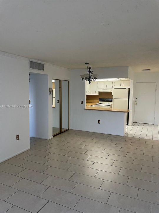 View of the Living Room and Kitchen. The entrance to the Master Bedroom and Master Bathroom ion the Left.