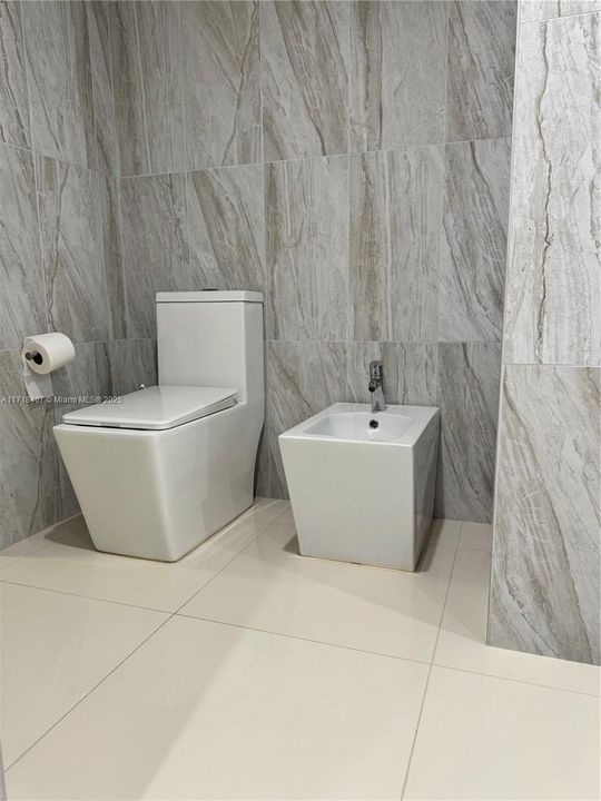 Primary bathroom with bidet and toilet