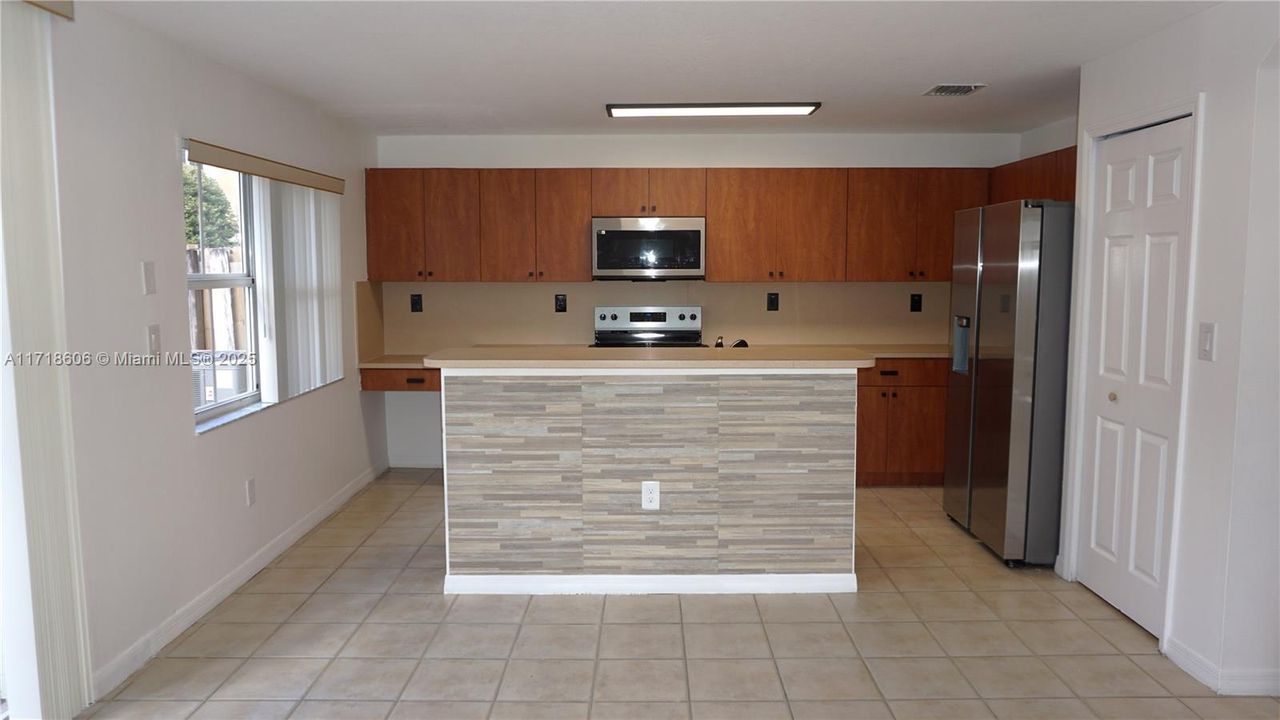 Kitchen with brand new SS appliances.