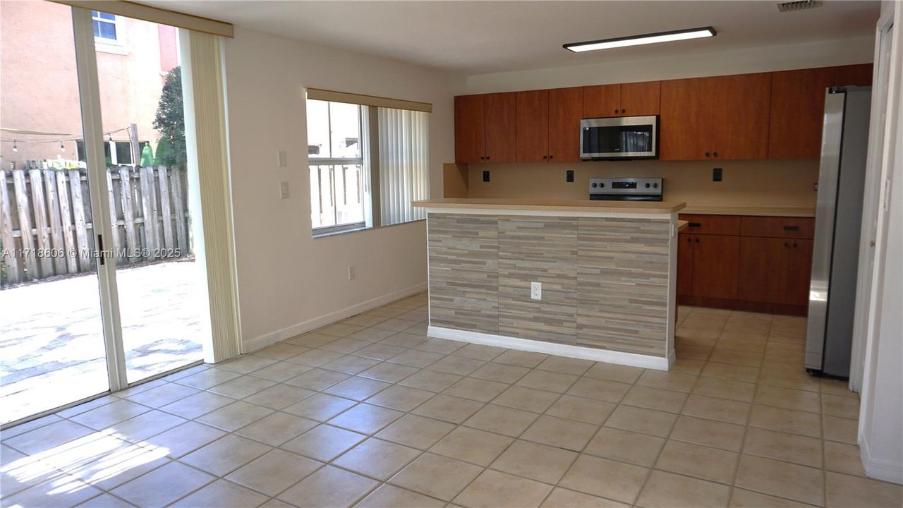 Very bright Kitchen and Family room area with access to the fenced patio.