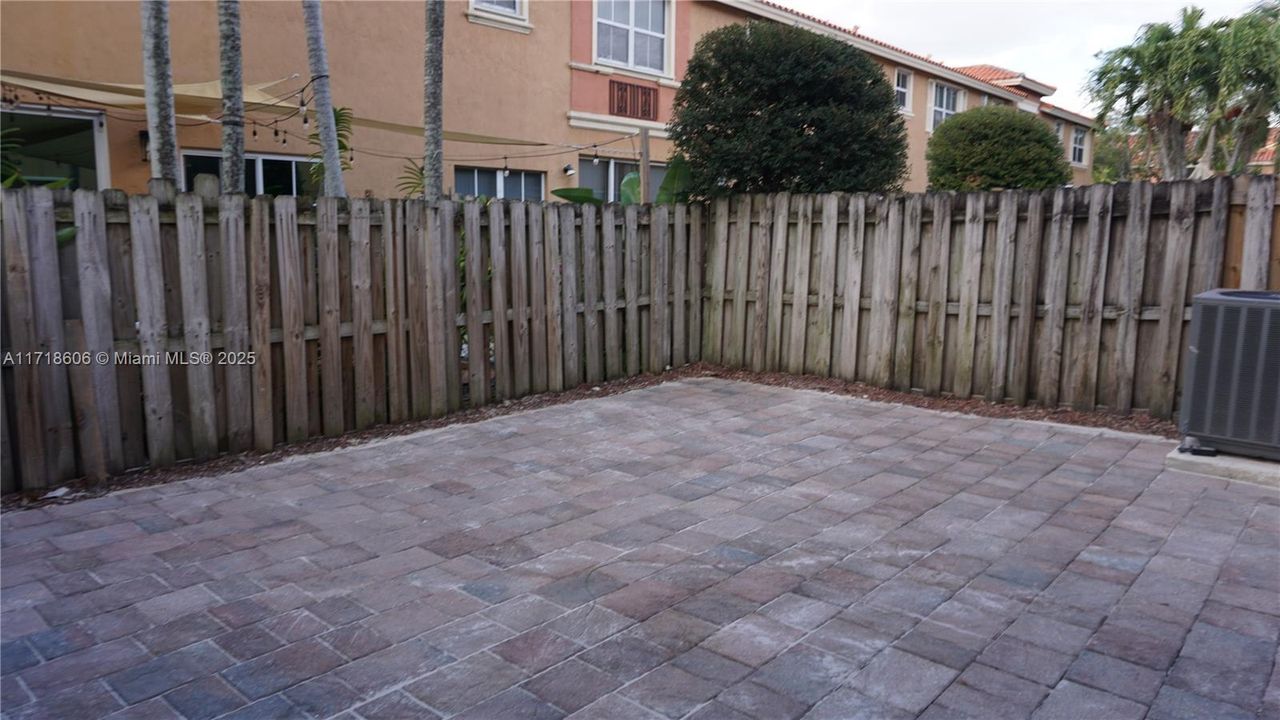 Fenced patio with paver.