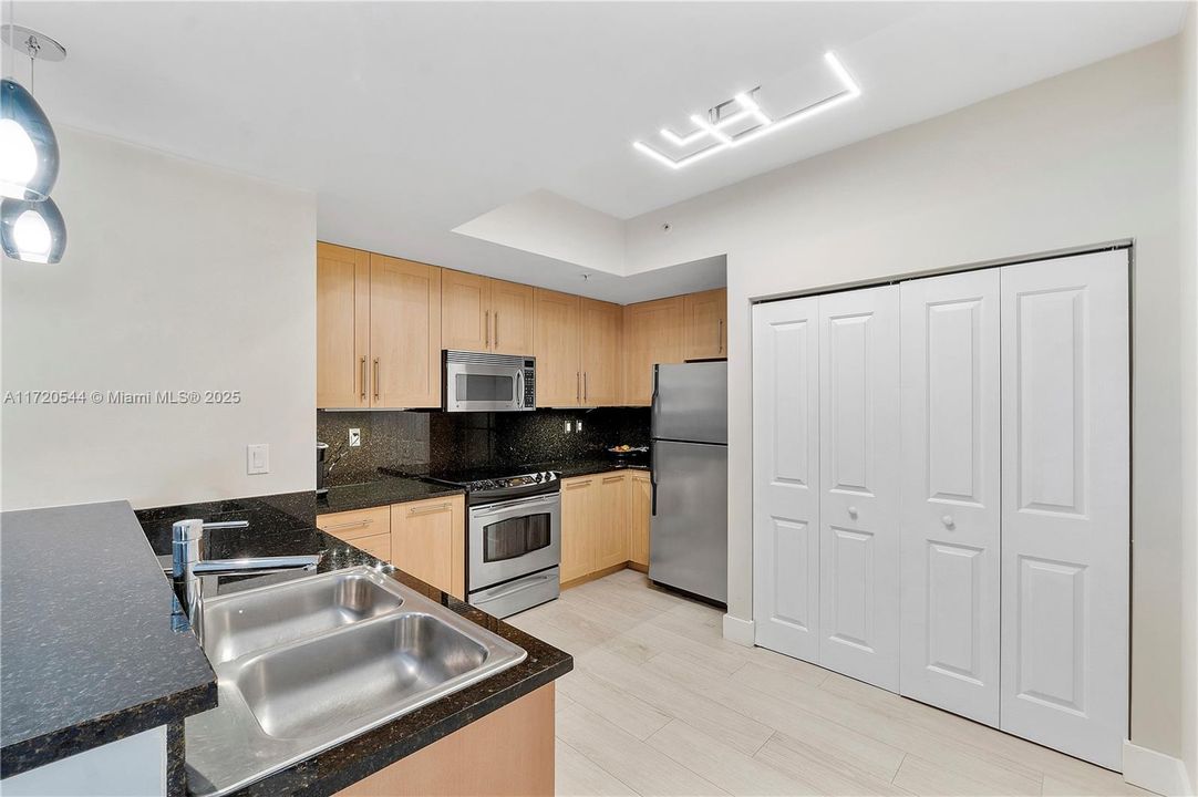 Modern kitchen with inside washer/dryer in closet.