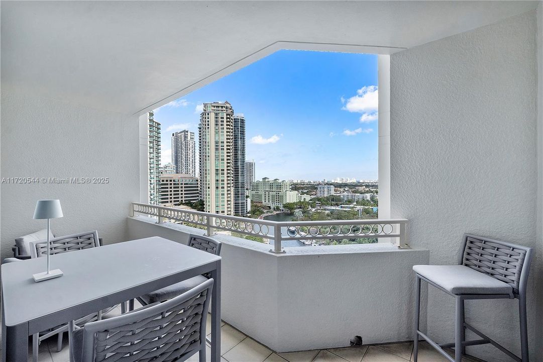 Oversized balcony with views of city, river and ocean.