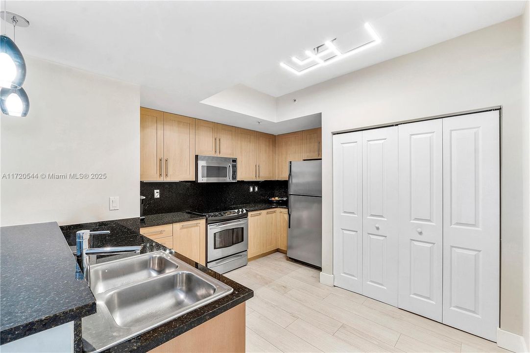 Modern kitchen with new pendant lighting and newer dishwasher