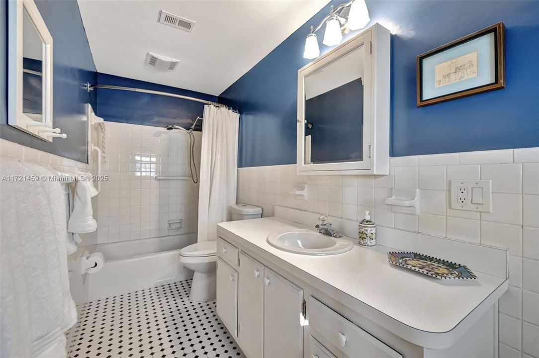 Full guest bathroom is a shared bathroom, adjoining two bedrooms. Features updated flooring.