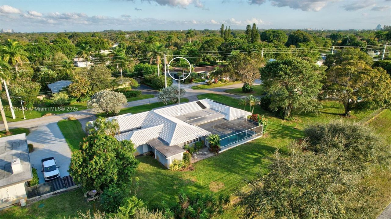 Great angle of property to see the wings of the home. Primary suite sits in the bottom left of this photo. Guest Bedrooms on right side wing of the photo. Awesome layout
