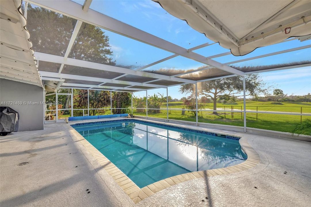 Large screened, solar heated pool w/ cover and baby gate (in garage).