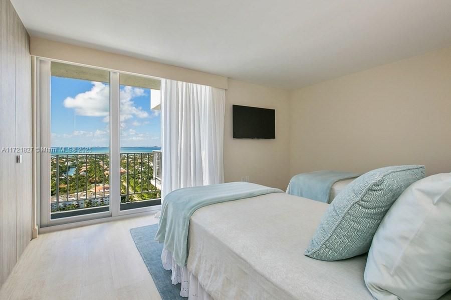 SECOND BEDROOM WITH BISCAYNE BAY VIEWS AND BUILT IN ITALIAN CLOSETS